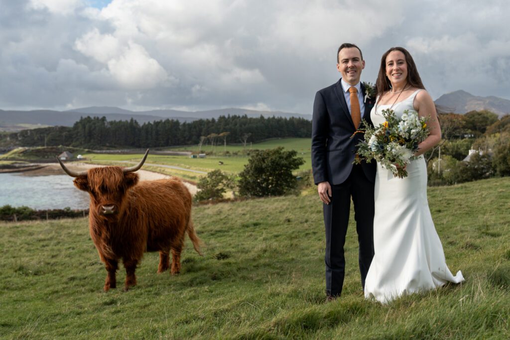 Bride and Groom with highland cow Isle of Raasay Photo Penny Hardie Photography