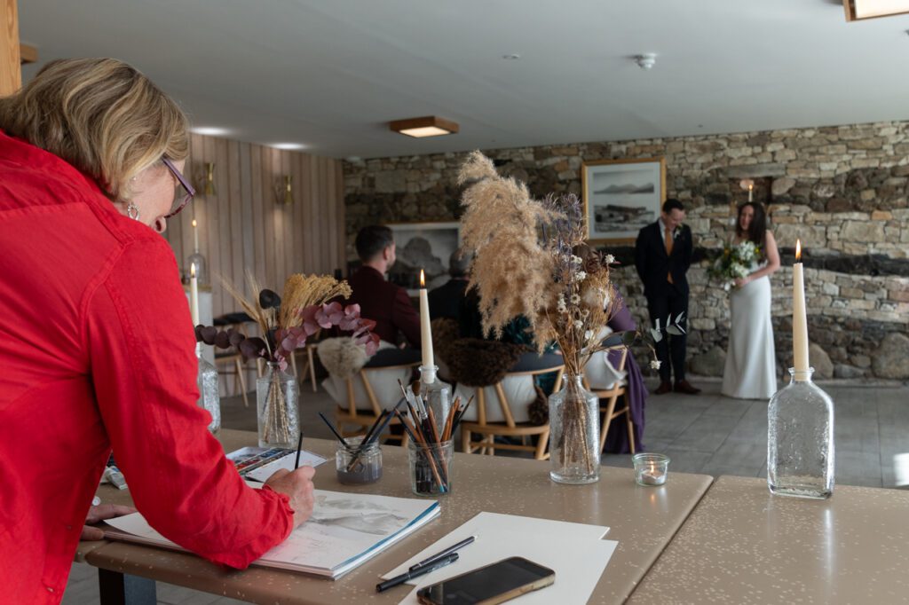 Rosie Woodhouse live painting at a wedding Raasay Distillery